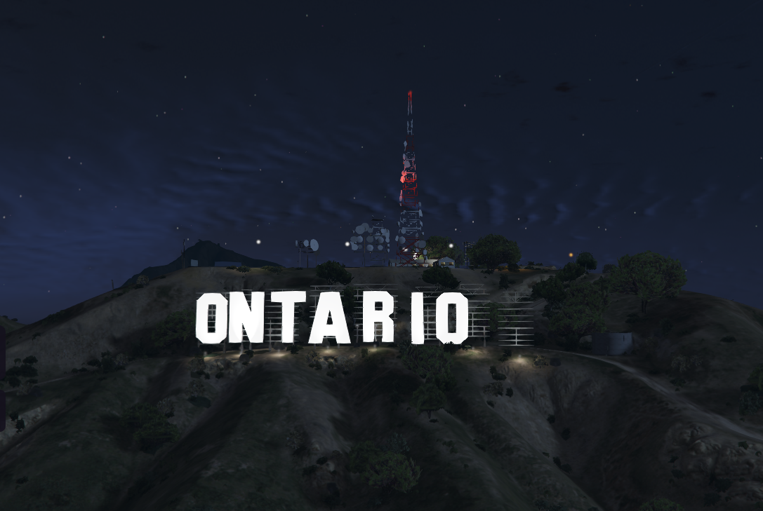 The illuminated Ontario hillside sign in 401RP at night